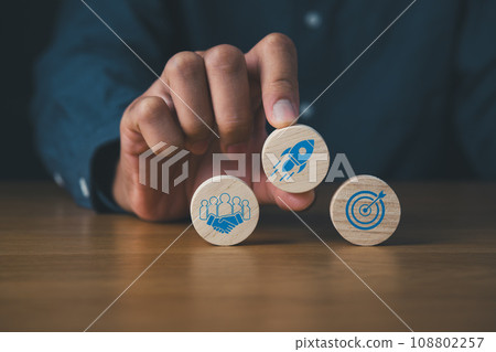 business goal achievement and objective concept.wooden circle of rocket hand and dart target. business goal achievement and objective concept.wooden circle of rocket hand and dart target. 108802257