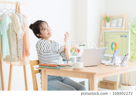 A young woman working from the living room during telework 108802272