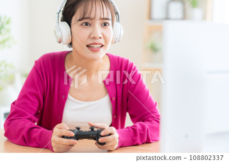 Young woman playing games in the living room 108802337
