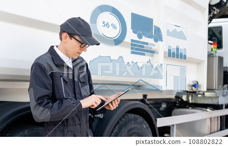 Manager with a digital tablet next to garbage truck 108802822