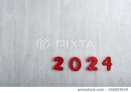 Glazed painted cookies with numbers 2024 on light wooden background. Copy space, mockup Glazed painted cookies with numbers 2024 on light wooden background. Copy space, mockup 108803659