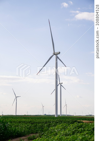 Agricultural field with wind turbines 108804528