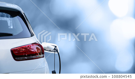 Close up of electric car inlet with a connected charging cable Close up of electric car inlet with a connected charging cable 108804545