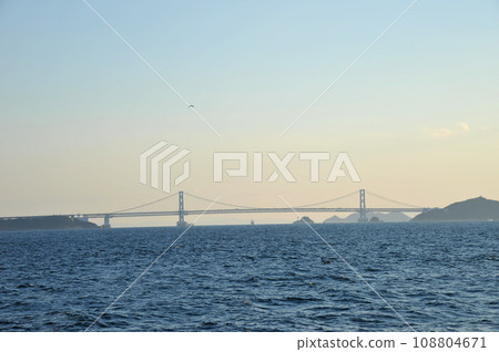 Naruto Strait and Onaruto Bridge illuminated by the setting sun Naruto Strait and Onaruto Bridge illuminated by the setting sun 108804671