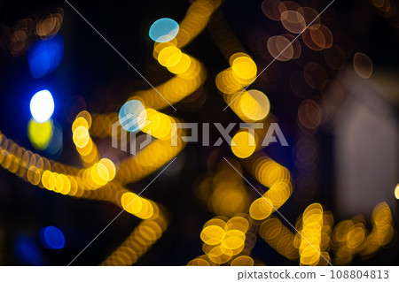 Blurred holiday background with bokeh. Defocused New Year and Christmas illumination Blurred holiday background with bokeh. Defocused New Year and Christmas illumination 108804813