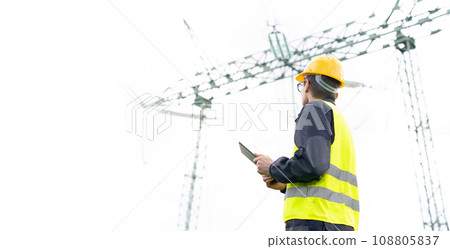 Engineer with digital tablet on a background of power line tower 108805837