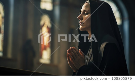 young Caucasian nun praying young Caucasian nun praying 108805879