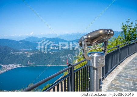 Paid tourist metal binocular above Lugano Lake, Italy and Switzerland Paid tourist metal binocular above Lugano Lake, Italy and Switzerland 108806149