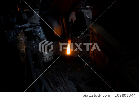 Photographing a blacksmith craftsman forging knives, which are essential tools for all traditional crafts. Photographing a blacksmith craftsman forging knives, which are essential tools for all traditional crafts. 108806344