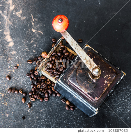 Old coffee grinder on black table 108807083