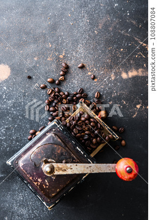 Old coffee grinder on black table Old coffee grinder on black table 108807084