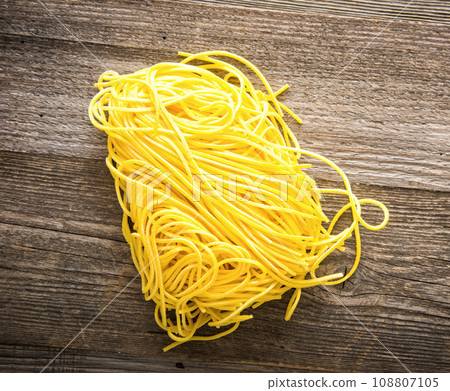 pasta on a dark wooden background pasta on a dark wooden background 108807105