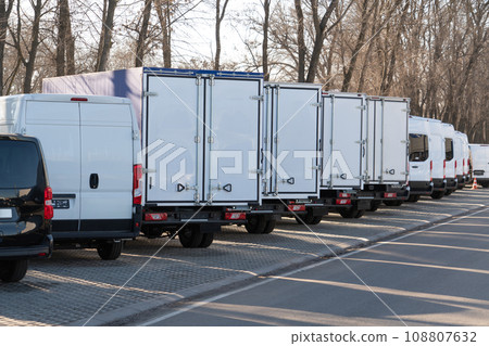 A lot of new trucks and vans in a row 108807632