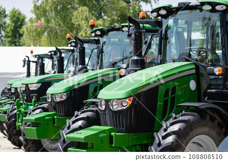 A row of green agricultural tractors A row of green agricultural tractors 108808510