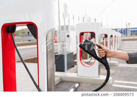 A man holds a charger plug 108809573