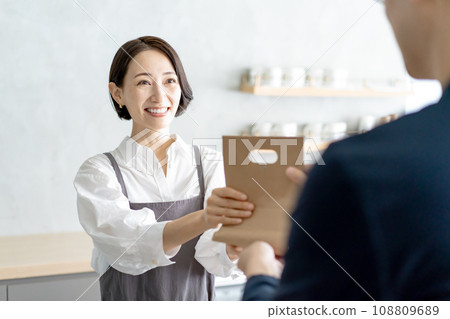 Woman working at a restaurant, takeout Woman working at a restaurant, takeout 108809689