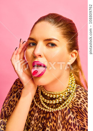 Close up portrait of woman looking at camera with capsule on her tongue. Young lady taking medications for her beauty 108809762