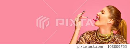 Banner. Close up side view portrait of woman put to mouth capsule, vitamin, pill, tablet isolated on pink studio background Banner. Close up side view portrait of woman put to mouth capsule, vitamin, pill, tablet isolated on pink studio background 108809763