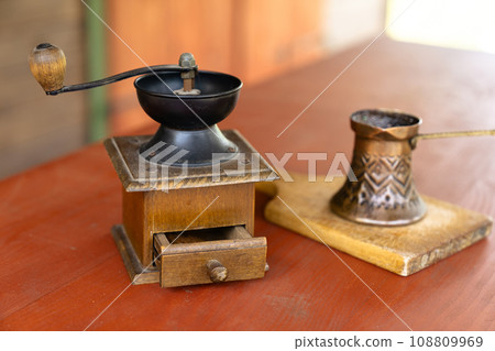 Vintage coffee pot and manual coffee grinder. 108809969