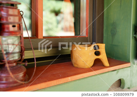 Traditional Finnish wooden mug kuksa and vintage lantern 108809979