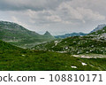 The road along the alpine meadows. High mountains. 108810171