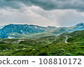 The road along the alpine meadows. High mountains. 108810172