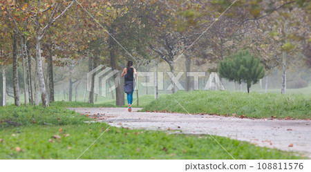 A woman running in park A woman running in park 108811576