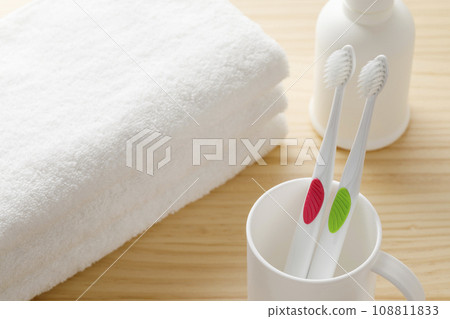 White toothbrush, cup and towel toothpaste image White toothbrush, cup and towel toothpaste image 108811833