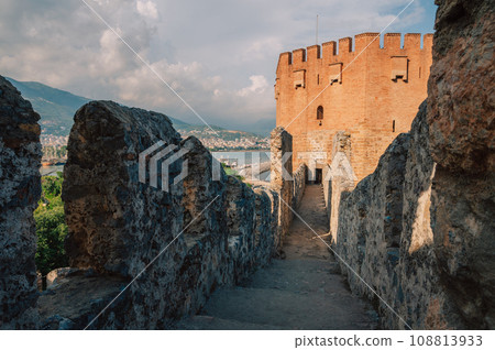 Fortress ruins of the historical Red Tower - Kizil Kule, in Alanya Castle. Fortress ruins of the historical Red Tower - Kizil Kule, in Alanya Castle. 108813933