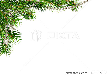 Christmas corner arrangement with green pine twigs and silver garland isolated on white 108815183