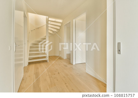 an empty room with wooden floors and white walls, there is a staircase leading up to the second floor in this photo 108815757