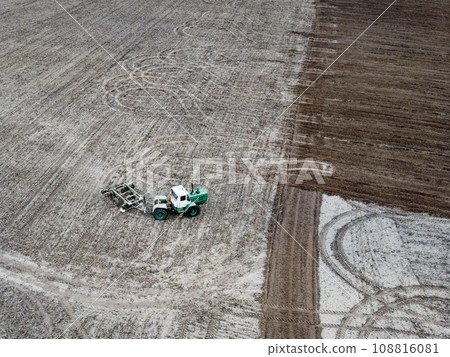 Tractor plows a field, aerial view. Agricultural landscape. Tractor plows a field, aerial view. Agricultural landscape. 108816081