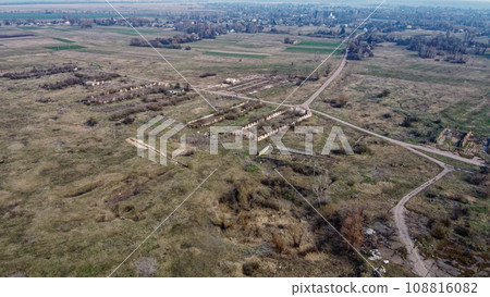 The ruins of a livestock farm, aerial view. Destroyed animal sheds. The ruins of a livestock farm, aerial view. Destroyed animal sheds. 108816082
