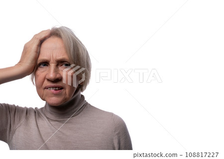 Portrait of an excited senior woman with gray hair on a background with copy space 108817227
