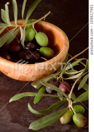 a wooden bowl with olives a wooden bowl with olives 108817981