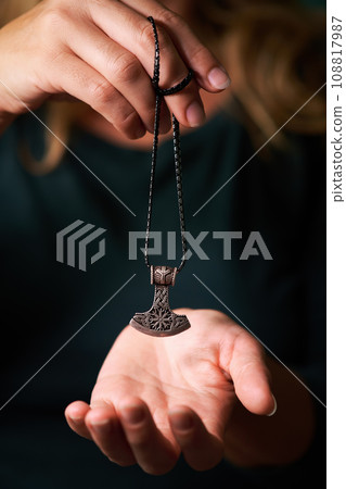 silver runic talisman hammer of thor in hand 108817987