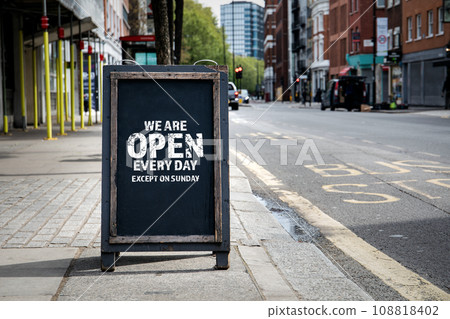 We are open every day except on Sunday. Foldable advertising poster on the street 108818402