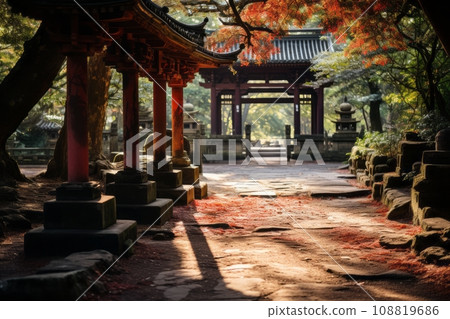A quiet approach to a shrine illuminated by the morning sun, a path with falling autumn leaves AI image 108819686