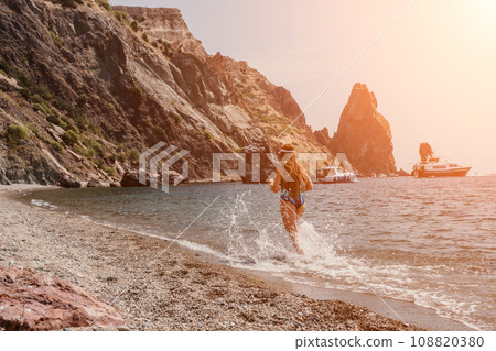 Fitness woman sea. Happy middle-aged woman in blue sportswear running on the beach, promoting a female fitness pilates yoga routine concept. Healthy lifestyle. Fitness woman sea. Happy middle-aged woman in blue sportswear running on the beach, promoting a female fitness pilates yoga routine concept. Healthy lifestyle. 108820380