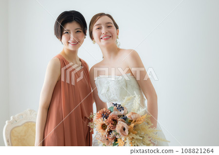 bride and friend with bouquet 108821264
