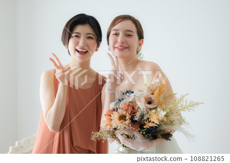 bride and friend with bouquet 108821265