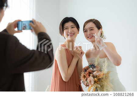 bride and friend with bouquet bride and friend with bouquet 108821268