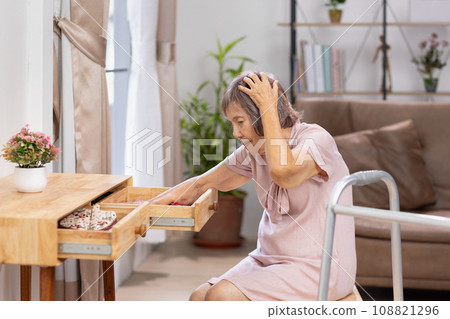 Asian Elderly woman looking for something that she forgot it in drawers. 108821296
