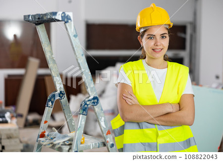 Portrait of young woman builder standing in apartment Portrait of young woman builder standing in apartment 108822043