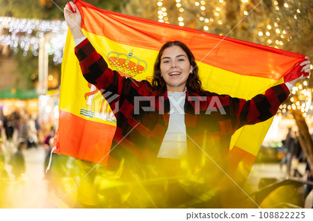 Happy girl with Spanish flag in street Christmas fair Happy girl with Spanish flag in street Christmas fair 108822225