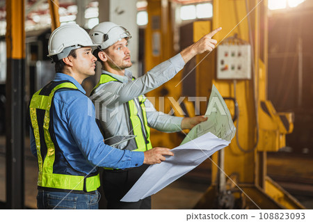 Construction engineer with technician designer team working build site inspect for interior renovate in industry workshop building with floor plan. Construction engineer with technician designer team working build site inspect for interior renovate in industry workshop building with floor plan. 108823093