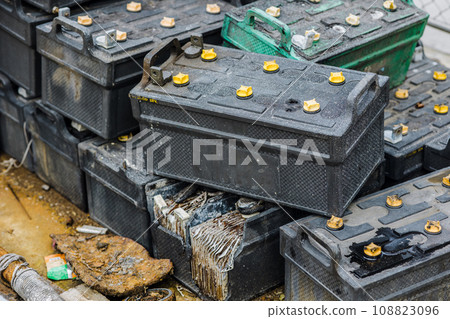 Battery waste. Pile of old used EV car batteries toxic waste chemicals lead leak impact nature no recycled. 108823096