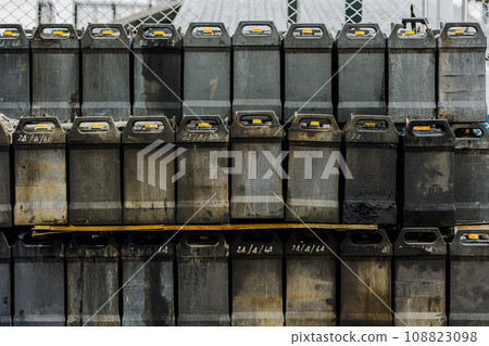 Battery waste. Pile of old used EV car batteries toxic waste chemicals lead leak impact nature no recycled. 108823098