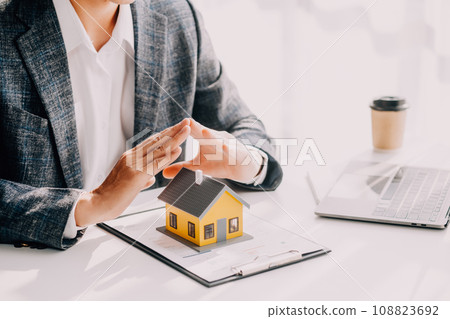 Real estate agent and customer signing contract to buy house, insurance or loan real estate.rent a house,get insurance or loan real estate or property. Real estate agent and customer signing contract to buy house, insurance or loan real estate.rent a house,get insurance or loan real estate or property. 108823692