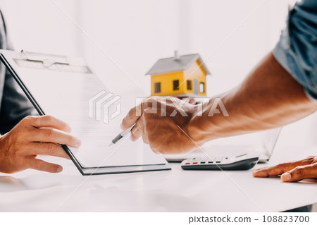 Real estate agent and customer signing contract to buy house, insurance or loan real estate.rent a house,get insurance or loan real estate or property. Real estate agent and customer signing contract to buy house, insurance or loan real estate.rent a house,get insurance or loan real estate or property. 108823700